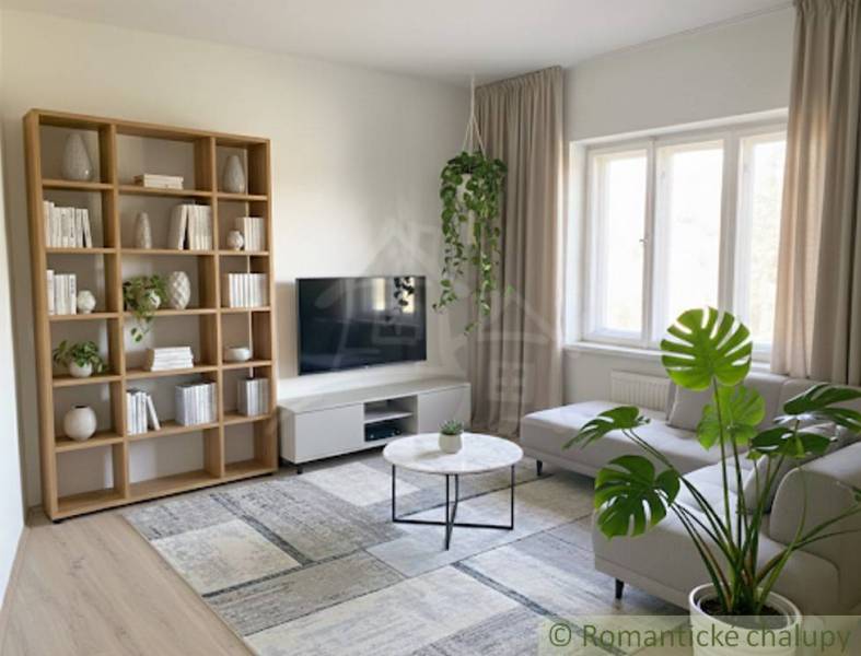 Rodinný dom v srdci Štiavnických vrchov, Štiavnické Bane. - Obývačka v rodinnom dome s poličkou, televízorom a kvetmi; podlaha s dreveným dekorom.