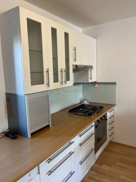 3-izb. byt, Palkovičova ul., Ružinov, lodžia, 4.p./12 - Biela kuchyňa s plynovým sporákom a vstavanou rúrou v 3-izbovom byte.