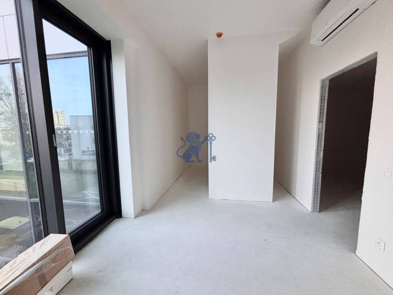 Na PREDAJ | 2 izb. ateliér | Prístavná ulica - Interiér 2-izbového bytu s veľkými oknami a podlahou s dreveným dekorom.