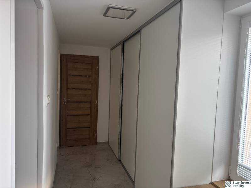 Prenájom komplet prerobený a zariadený  RD 3 izb. Blatné  - Chodba v rodinnom dome s posuvnou skriňou a drevenými dverami.