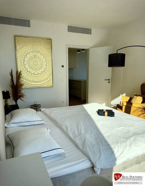 Prenájom 3-izbový byt s loggiou, SKY PARK, Bratislava - Spálňa v 3-izbovom byte s dvojposteľou, zlatým obrazom a bielou posteľnou bielizňou.