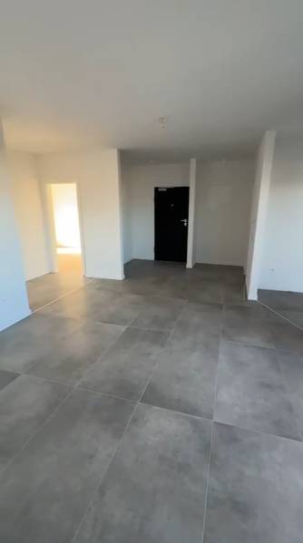 CHORVÁTSKO - Nové apartmány v pokojnej lokalite - SABUNIKE, Nin - Interiér 3-izbového bytu s veľkými dlaždicami a bielymi stenami.