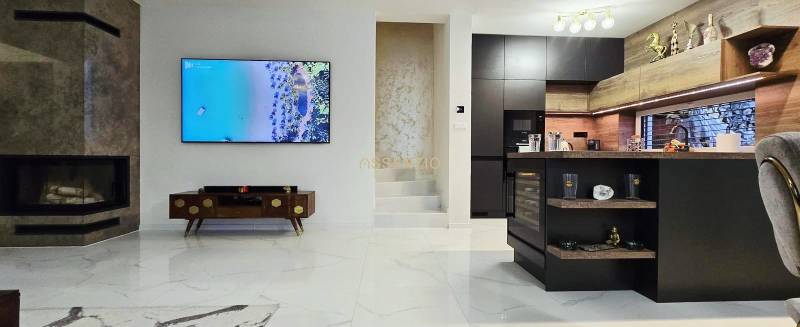 - KRÁTKODOBÝ PRENÁJOM - RODINNÝ DOM - 105 m2 - ROVINKA - Obývačka v rodinnom dome s krbom a kuchynským ostrovom, podlaha s dreveným dekorom.