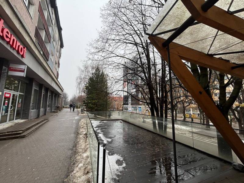 Exkluzívne - Obchodný priestor na prenájom v centre mesta Poprad - Obchodné priestory v Poprade vedľa preskleného zábradlia a mokrej dlažby, zasnežený chodník.