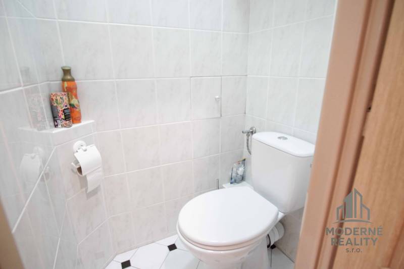 Na prenájom veľký 4-izbový byt s balkónom, garážou a záhradou, Kolta – - Toaleta s keramickými obkladačkami, držiak na toaletný papier, dekoratívne doplnky, 4-izbový byt.