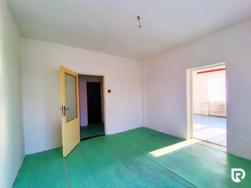 Rodinný dom v obci Borskom Mikuláš. - Interiér rodinného domu s otvorenými dverami, bielymi stenami a zelenou podlahou.