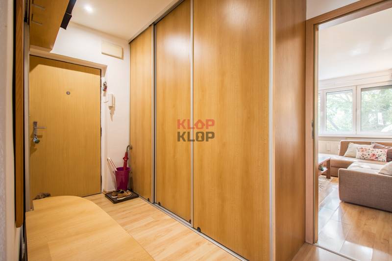 Pozrite si PRÍJEMNÝ 2i byt so ZARIADENÍM, LODŽIOU a KLIMATIZÁCIOU - Vstupná chodba s podlahou s dreveným dekorom a vstavanou skriňou v 2-izbovom byte.