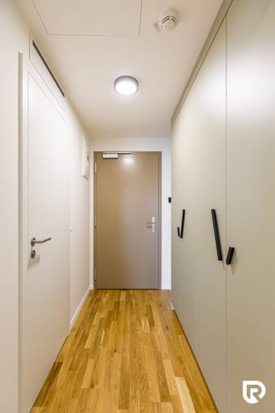 REZERVOVANÉ I METROPOLIS I Luxusný 1i byt I Staré Mesto - Chodba v 1-izbovom byte s podlahou s dreveným dekorom a vstavanými skriňami.