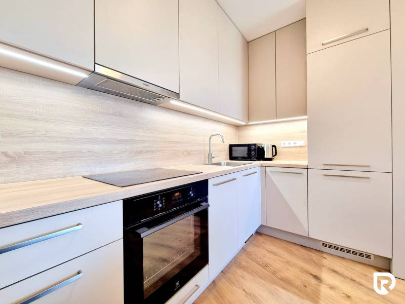 Posledný investičný krásny 2-izbový byt | 55 m² | RÍNOK RAČA - Kuchyňa v 2-izbovom byte s podlahou s dreveným dekorom a vstavanými spotrebičmi.