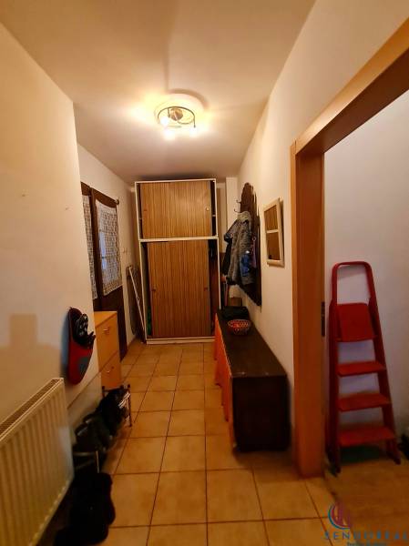 4.izb Rodinný Dom Centrum Chtelnica - Chodba v rodinnom dome s dlažbou, botníkom, vešiakom a skriňou.
