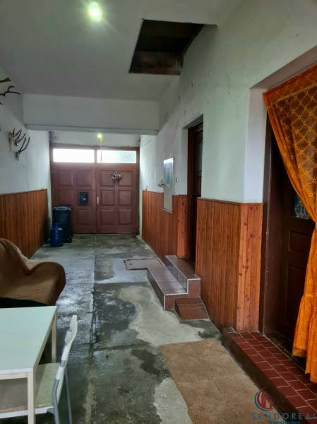 4.izb Rodinný Dom Centrum Chtelnica - Interiér rodinného domu so vstupnými dverami, stoličkou a dekoráciou na stenách.