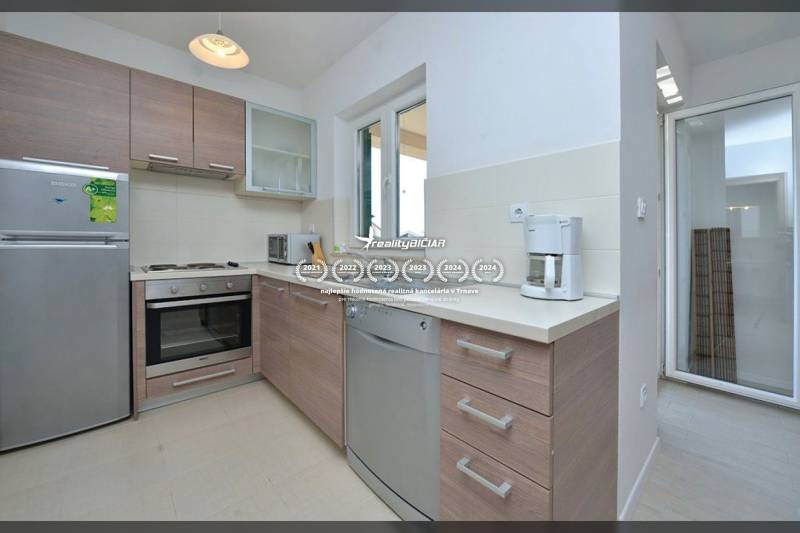 PRIVLAKA - BYT S4- dvojizbový byt 63,42 m2 vzdialený 150 m od mora - Kuchyňa v 2-izbovom byte s vybavením a podlahou s dreveným dekorom.