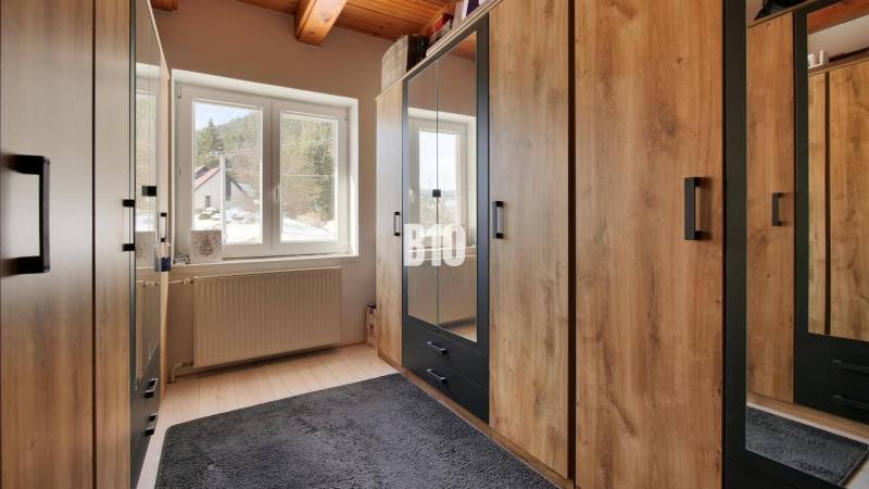 Praktický 8-izbový rodinný dom na Bystričke: Vhodný pre veľkú rodinu z - Šatník v Rodinnom dome s podlahou s dreveným dekorom a veľkými skriňami.