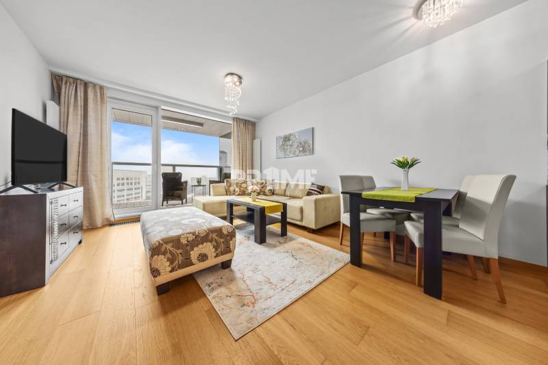 KRÁSNY 2i byt, KLÍMA, LOGGIA,VÝHĽAD,PANORAMA CITY, Landererova ulica - Obývacia izba 2-izbového bytu s podlahou s dreveným dekorom, sedačkou a jedálenským stolom.