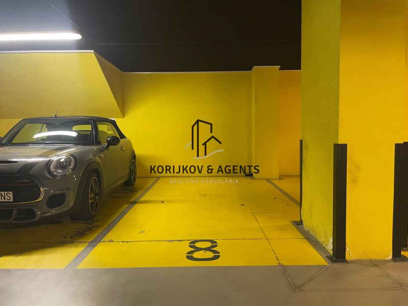 PRENÁJOM, 2 izbový byt na Fatranskej ulici, Nová Terasa, Košice-Západ - Parkovacie miesto s automobilom v garáži. Žlté steny a označenie parkovania čísla 8.
