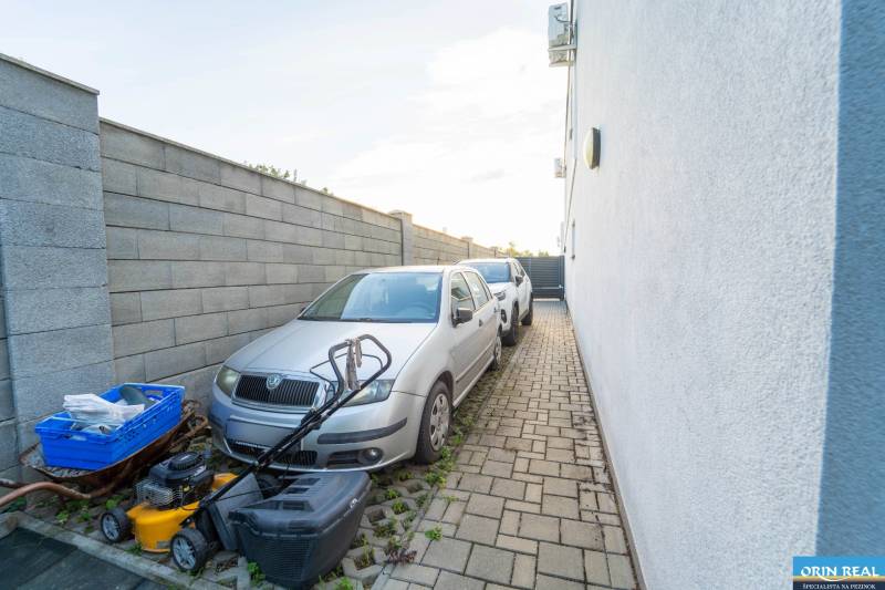 ATRAKTÍVNY 2 IZBOVÝ BYT S VLASTNOU ZÁHRADKOU a 3 parkovacími miestami - Parkovisko s dvomi autami a kosačkou vedľa budovy na Žitavskej ulici v Senci.