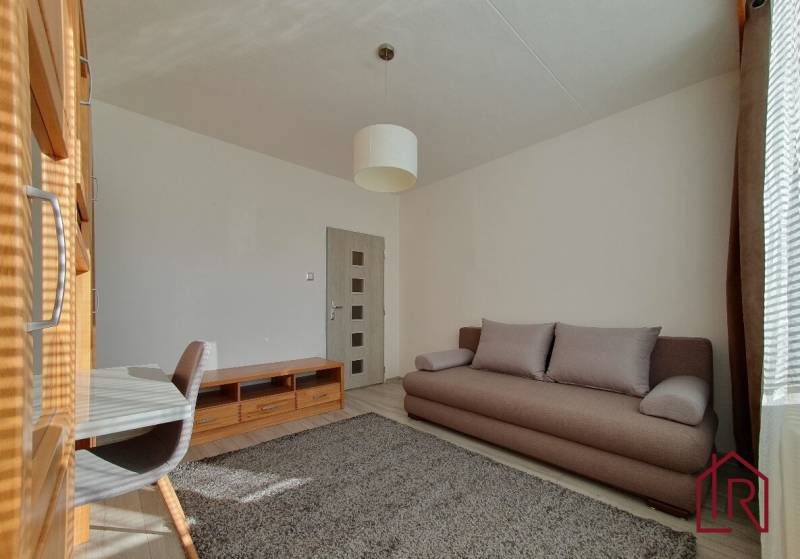 KH-1052, 3 izbový byt, Košice – Staré Mesto, širšie centrum, Kuzmányho - Obývačka v 3-izbovom byte s pohovkou, koberec a podlaha s dreveným dekorom.