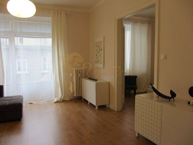 4-izb.byt v centre mesta, Obchodná ul., BA I - Staré Mesto, 2 x balkón - Interiér 4-izbového bytu s podlahou s dreveným dekorom a jednoduchým nábytkom.