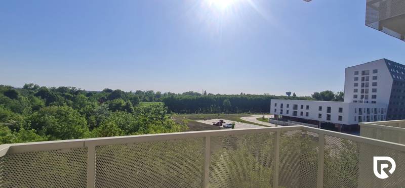 Zariadený 2-izb. byt v novostavbe v Ružinove - Ovocné sady - Výhľad z balkóna v Bratislave - Ružinov na Ivanskej ceste s budovami a zeleňou.