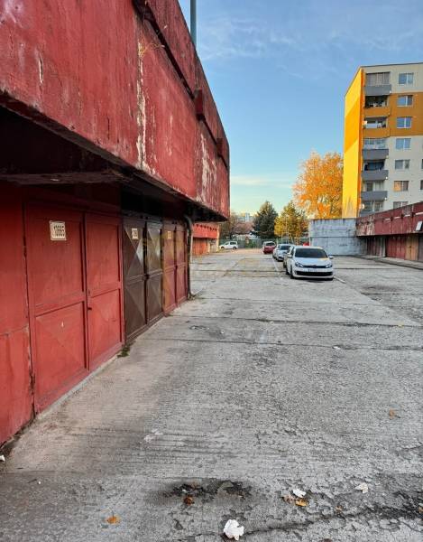 Garáž Bebravská ul., Vrakuňa s pozemkom - Garáže na Bebravskej ulici v Bratislave - Vrakuni, vedľa obytných domov a áut.