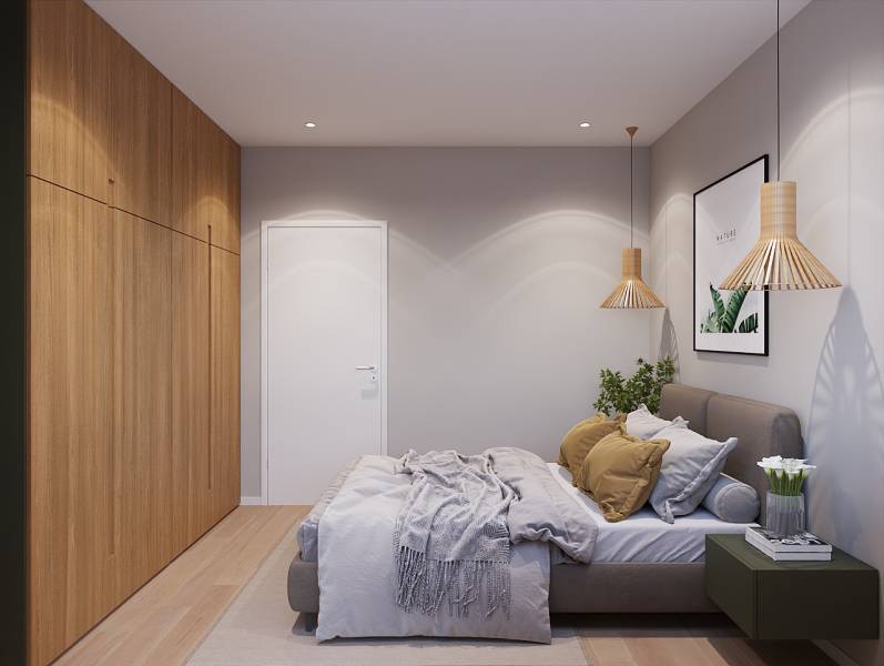 Pripravujeme: Moderná novostavba bytového domu, Byty Maty - Spálňa v 1-izbovom byte s posteľou, rastlinou a dreveným dekorom na podlahe.