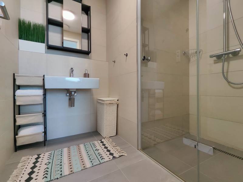 NUERA︱SKY PARK Moderný 2-izbový byt na 6. poschodí, veža 3 - Kúpeľňa v 2-izbovom byte s umývadlom, zrkadlom, sprchovým kútom a koberečkom.