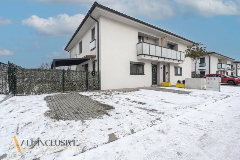 Rezervované 3-izbový byt so záhradou, Šamorín - Rodinný dom na zasneženej ulici Kráľovianky v Šamoríne s parkoviskom pred vstupom.