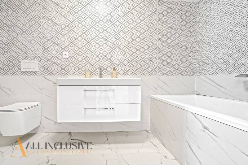 NA PRENÁJOM 3-IZB BYT S BALKÓNOM A ZÁHRADOU,DUN.STREDA - Kúpeľňa v 3-izbovom byte s vzorovanými obkladmi a vaňou.