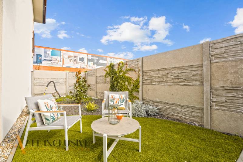 NA PRENÁJOM 3-IZB BYT S BALKÓNOM A ZÁHRADOU,DUN.STREDA - Veľká terasa s pohodlným sedením, trávnatou plochou a dekoratívnou stenou v Dunajskej Strede.