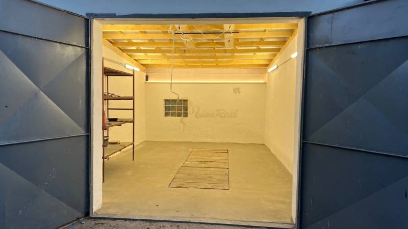 Zrekonštruovaná veľká garáž na ul. Agátova, Dúbravka s pozemkom - Otvorená garáž s regálom na Agátovej ulici v Bratislave - Dúbravke.