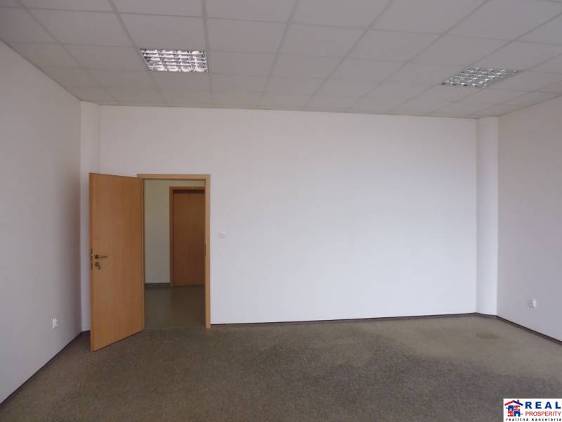 MASARYKOVA: Nebytové priestory 30 m2 - 3.posch., VÝŤAH, parkovanie - Biela miestnosť v kancelárii s otvorenými drevenými dverami a kobercom na podlahe.