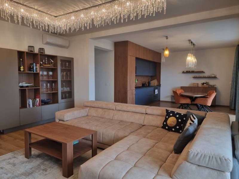 CHORVÁTSKO - Luxusne zariadený 3 izbový apartmán - VRSI, Zadar - Obývačka v 3-izbovom byte s pohovkou, lustrom a kuchyňou v pozadí.