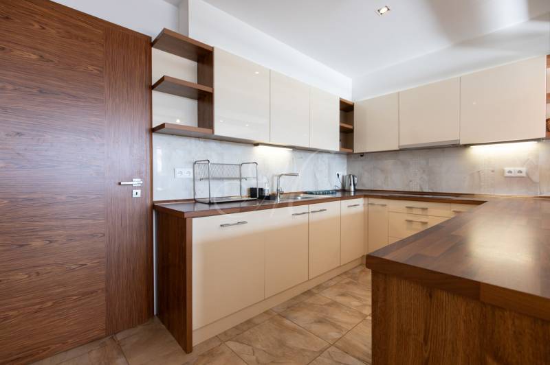 Moderný 2-izbový byt s balkónom, Eurovea - Kuchyňa v 2-izbovom byte so svetlými skrinkami a podlahou s dreveným dekorom.