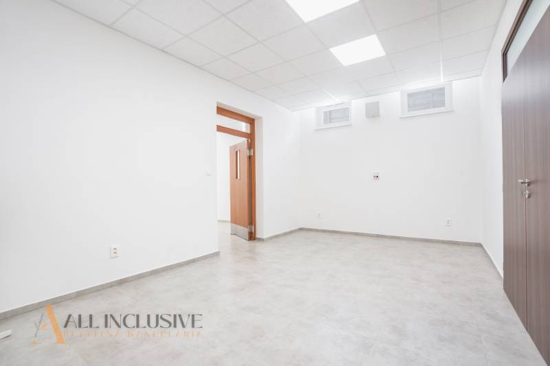 NA PRENÁJOM OBCHODNÝ PRIESTOR-KANCELÁRIA ,DUN. STREDA - Svetlá prázdna kancelária na ulici Jilemnického s dlažbou a drevenými dverami.