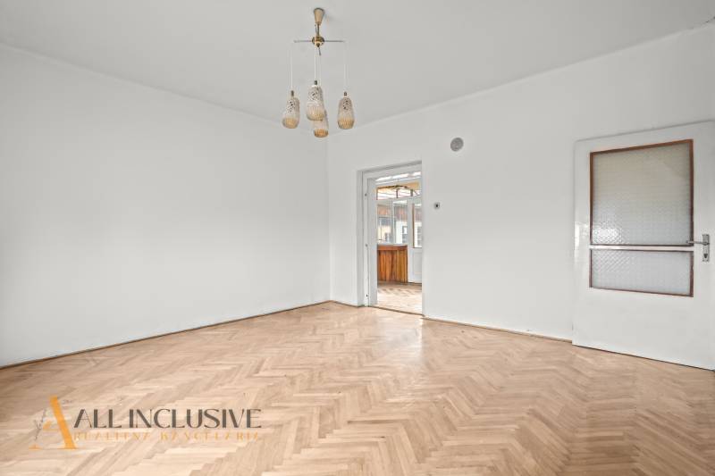 REZERVOVANÉ 4-IZBOVÝ RODINNÝ DOM, TOPOĽNÍKY - Priestranná miestnosť v rodinnom dome s podlahou s dreveným dekorom a bielym stropom.