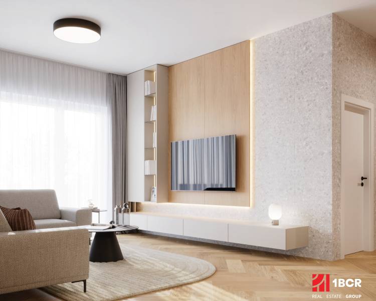 PROJEKT POD VINICOU | 4-IZB. BYT, UZAVRETÝ AREÁL, HOLOBYT, NOVOSTAVBA - Obývačka v 4-izbovom byte s podlahou s dreveným dekorom, svetlou sedačkou a TV na stene.