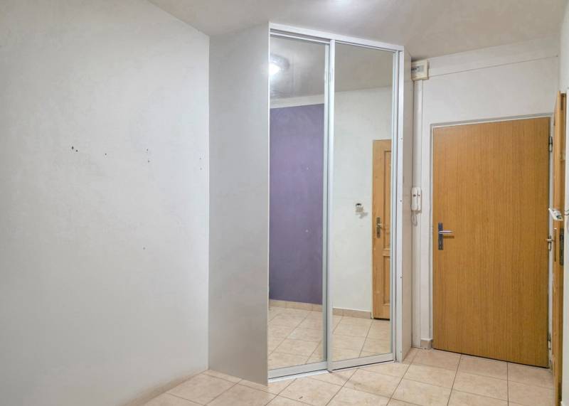 PREDAJ - 2-izbový byt pripravený na rekonštrukciu - Nitra, Chrenová - Vstupná hala v 2-izbovom byte s dlažbou a zrkadlom na skrini.
