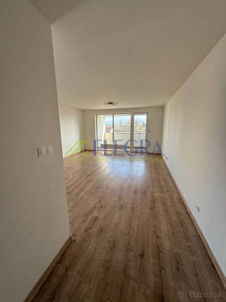 Na predaj 2 izbový byt GEENSIDE Trebišov - Svetlá obývacia izba s podlahou s dreveným dekorom v 2-izbovom byte.