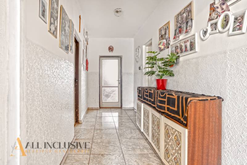 NA PREDAJ 5-IZBOVÝ RODINNÝ DOM NA 15Á POZEMKU,ŠALGOČKA - Chodba rodinného domu s izbovou rastlinou, fotkami na stenách a svetlou dlažbou.