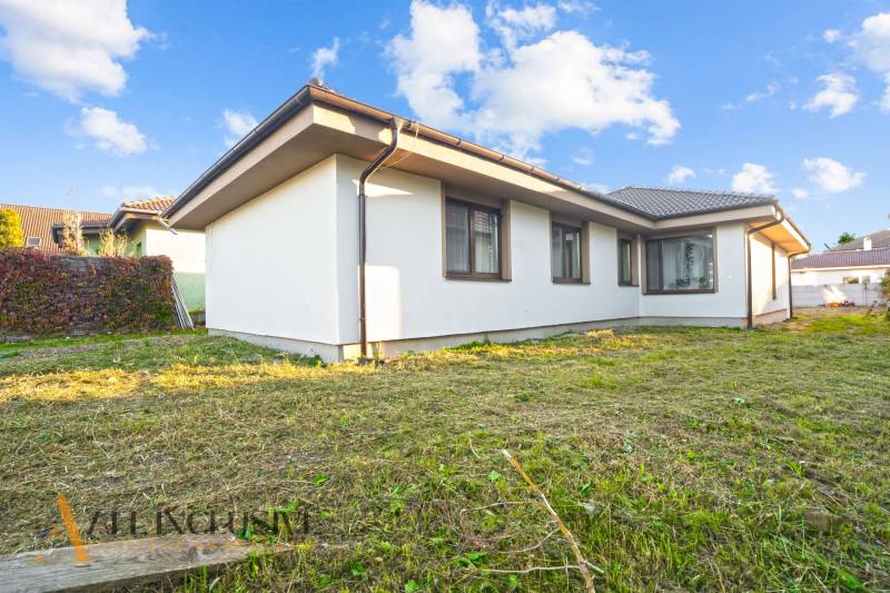 REZERVOVANÉ 5-IZBOVÝ RODINNÝ DOM VO VEĽKEJ PAKE - Rodinný dom vo Veľkej Pake s upraveným trávnikom a svetlou fasádou.