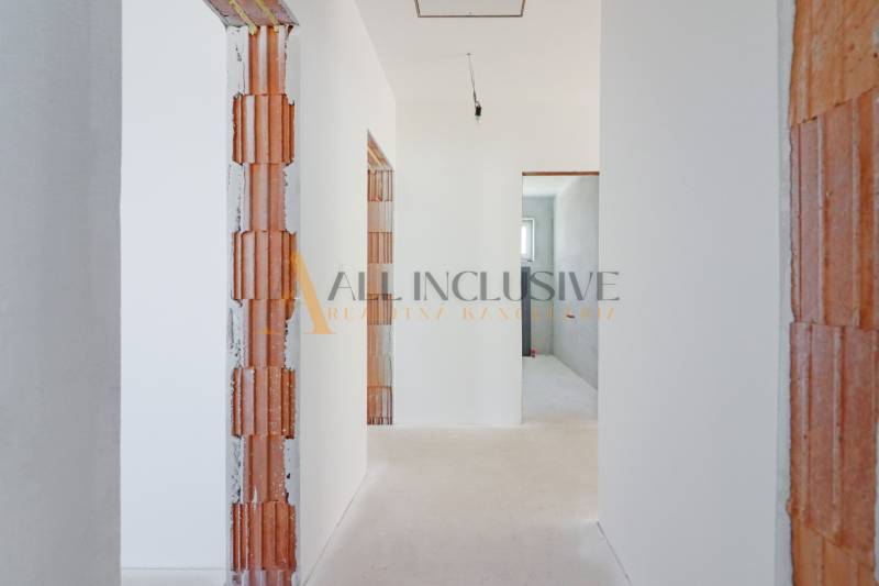 NA PREDAJ 4 IZBOVÝ RODINNÝ DOM-NOVOSTAVBA, KRÁĽOV BROD - Chodba vo výstavbe v byte, odhalené murivo, biele steny, rodinný dom.