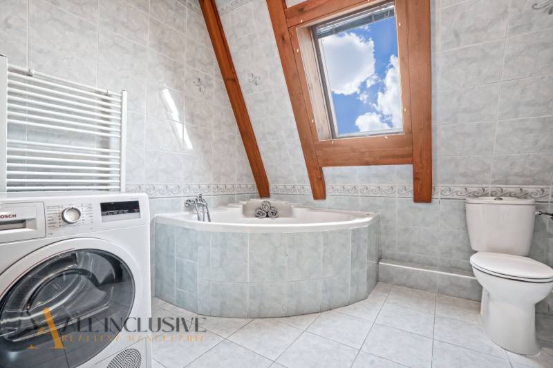 REZERVOVANÉ ZREKONŠTR. 6 IZBOVÝ RODINNÝ DOM, KOŠÚTY - Kúpeľňa v rodinnom dome s rohovou vaňou, práčkou a strešným oknom.