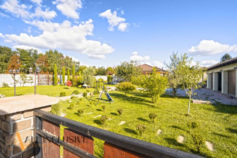 NA PREDAJ 4-IZB NOVOSTAVBA S TROJGARÁŽOU, PIN. KRAČANY - Záhrada rodinného domu v Pinkových Kračanoch, Dunajská Streda s trávnikom a hojdačkou.