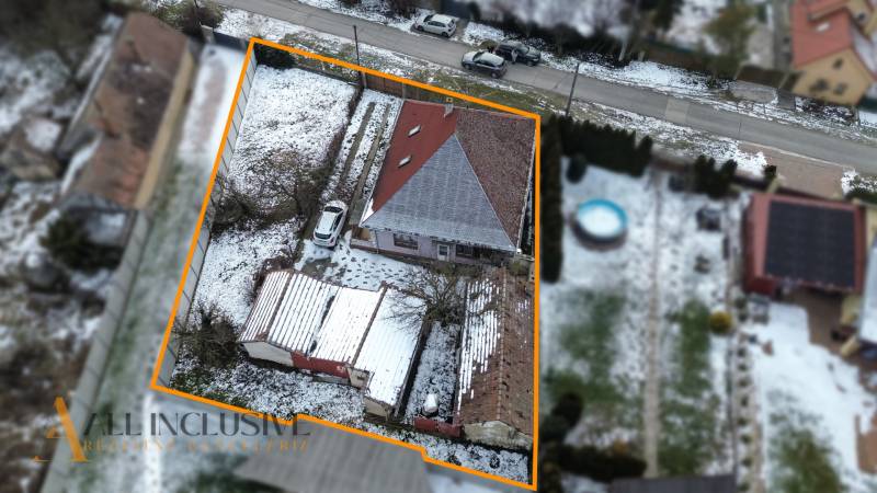 Na predaj 3-izbový rodinný dom, Dobrohošť - Rodinný dom v Dobrohošti s červenou strechou, zasneženou záhradou a parkoviskom.