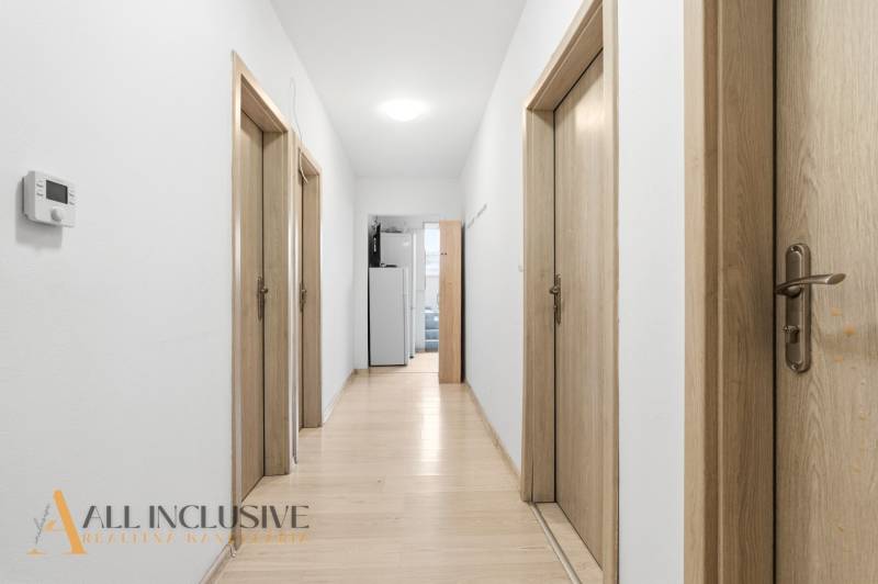 Na predaj 3-izbový byt so záhradkou, Senec - Chodba s bielymi stenami, podlahou s dreveným dekorom a drevenými dverami v Hotely a penzióny.