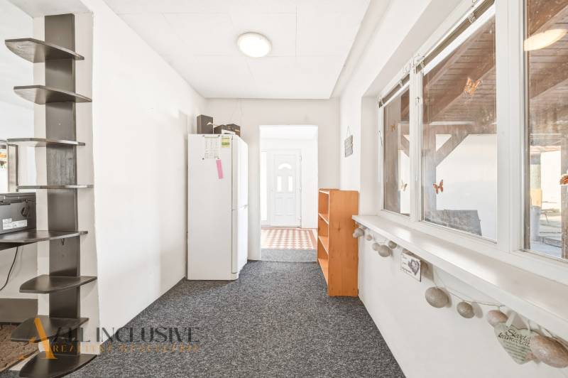 Na predaj 3-izb.rod.dom s dvojgarážou,Vojka nad Dunajom - Rodinný dom s chodbou, podlaha s dekorom, poličky, biela chladnička a veľké okno.