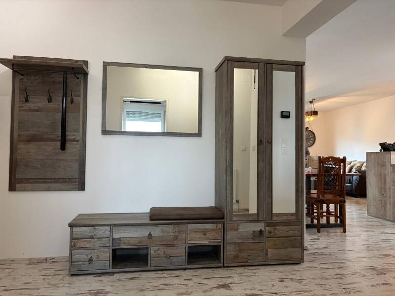 Zariadený 3 izbový byt s balkónom v Kittsee  - Chodba v 3-izbovom byte s vešiakom a skriňou, podlaha s dreveným dekorom.