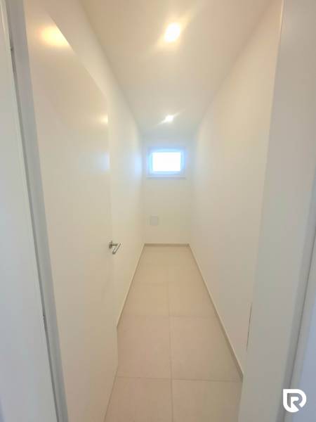 | 4 izbový rodinný dom s krbom a terasov | Slnečná | Ružindol - Úzka biela chodba v rodinnom dome s malým oknom a dlažbou.