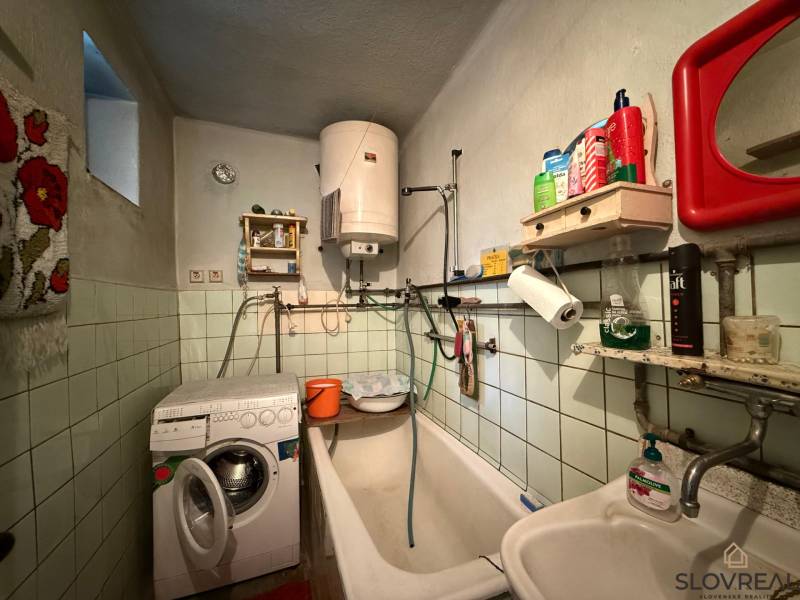 Predaj domu v Janovej Lehote - Kúpeľňa v rodinnom dome s práčkou, vaňou a bojlerom.