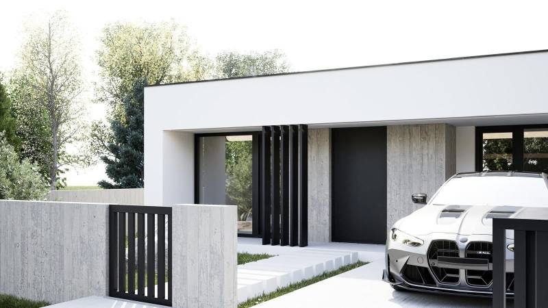 Na predaj 4-izb. rodinné domy, Nesvady - Jednopodlažný rodinný dom v Nesvadoch s automobilom BMW na príjazdovej ceste.